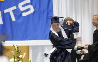 Interlake High School graduate Tommy Bentley receives his diploma from his father