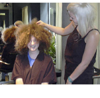 Hairstylist Summer Potter checks the work cut out for her from Robby’s locks.