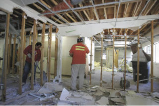 Workers break down the interior of the AtWork! building on Bel-Red Road on Tuesday