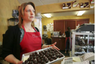 Amore Chocolate owner Brenda Archuletta shows chocolate balls that they make from scratch at the store