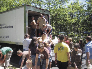 Youth from the Church of Latter-day Saints load food into a Northwest Harvest truck after collecting it from several grocery stores July 12.
