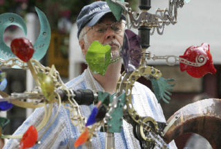 Larry Hay checks out Andrew Carson’s kinetic sculpture at the Bellevue Arts Museum ArtsFair on Friday