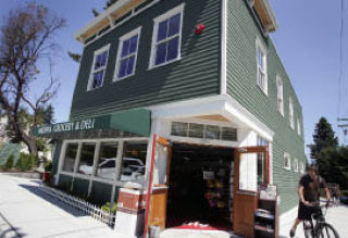 Rebuilding of the Medina Market included using familiar green paint carefully matched to siding saved from the original structure