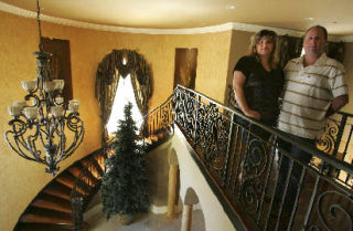 Out of This World Finishes owners Susan and Todd Allemand pose in a Clyde Hill home that they have redone.