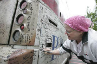 Cancer survivor Elaine Montgomery signs the Fight Back Express as part of the American Cancer Society’s effort to get public officials involved in providing money to fight the disease.