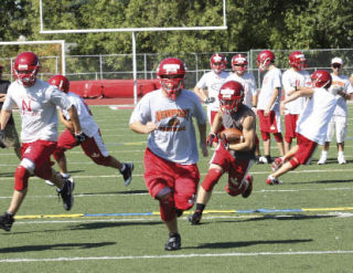 Senior fullback Ian Case runs the ball during Newport’s Friday practice on Aug. 22.