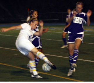 Bellevue junior defender Samantha McKee works around a host of Issaquah players in Tuesday’s 2-0 loss to the Eagles. The Wolverines travel to face Ballard today at 3 p.m.