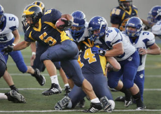 Senior running back Peter Nguyen carries the ball in the first quarter of Bellevue’s win over Bothell on Friday. Nguyen rushed for 111 yards and three touchdowns.