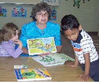 Esther Harmon works with some of her students at the Sunday School at the Neighborhood Church.
