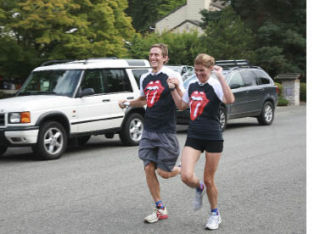 Nick Merrill and his wife Liz Strathy-Merrill run the final feet of their Portland-to-Bellevue run to benefit the Drop in the Bucket foundation