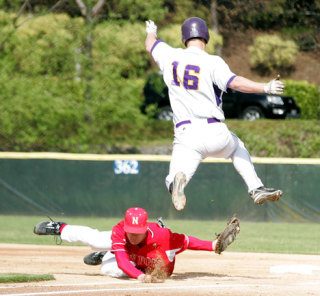 Newport’s Will Pierce reaches out to tag Issaquah’s Kyle Sutherland (16) at Bannerwood Park on May 8.