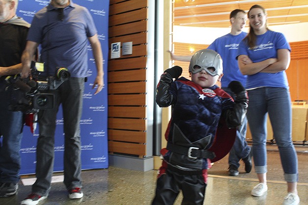 Aiden Lescher shows off his crime-fighting muscles in his Justice Boy costume.