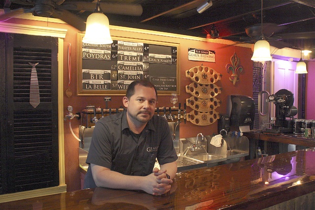 Jeremy Hubbell leans on the bar in his New Orleans-inspired brewery. Geaux Brewing is planning a major expansion to Auburn later this year.