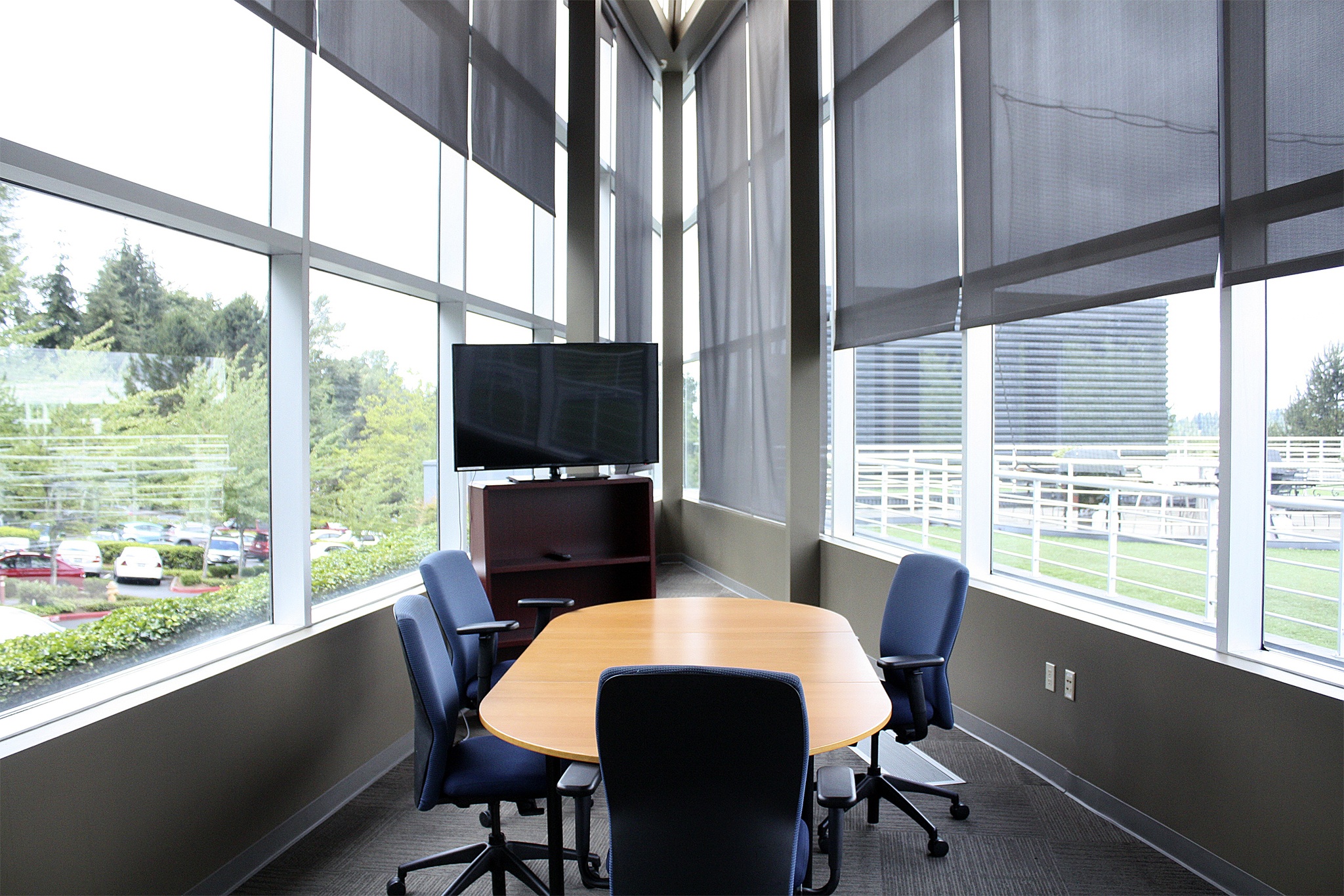 The "Atrium" conference room at Bellevue co-working startup extraSlice provides ample natural light at the Eastgate campus. An outdoor volleyball court and grilling area provide a comfortable environment for tenants.