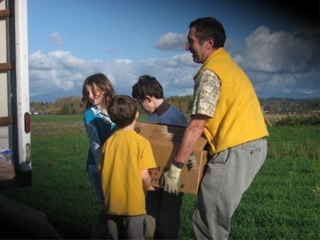 Members of Temple B'Nai Torah in Bellevue load boxes of fresh produce from Stocker Farms for delivery to Northwest Harvest.