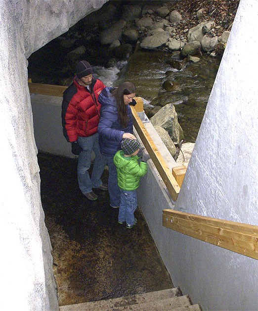 Jim and Laurie Devereaux look for salmon with their son