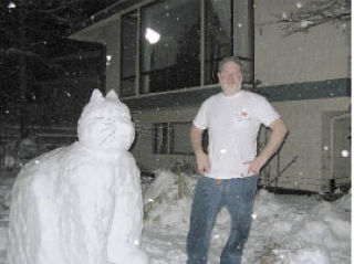 Bruce Mayer stands next to a ‘Snow Cat’ that he and neighbors created in Bellevue on Monday