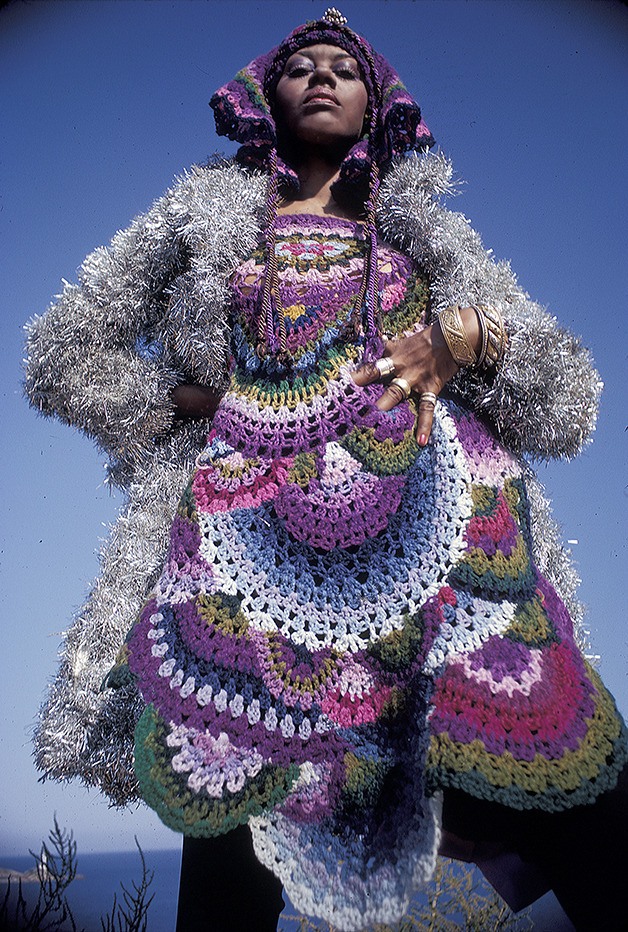 A model wears a brightly colored crocheted dress made by Birgitta Bjerke. Making clothes by hand and depurposing items was an integral part of fashion in the era