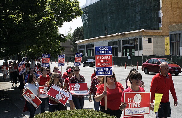 Protesters advocating for increased school funding from the state Legislature march down Bellevue Way. The Bellevue protest was one of 60 planned across the state.