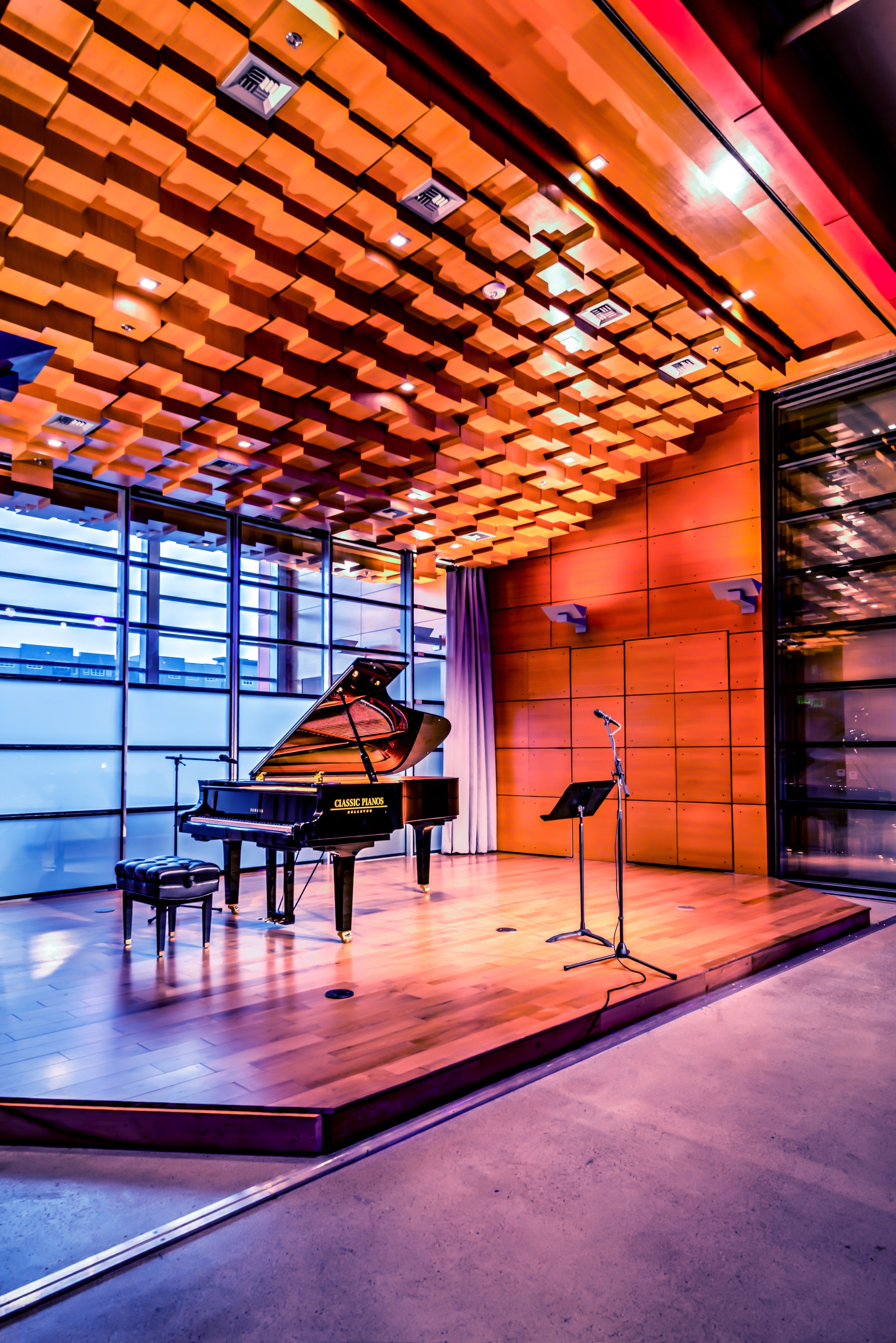 The interior of Resonance at SOMA Towers is designed for classical musicians to practice and perform to either a theater or table-top setting. Windows open to the street to allow passersbys to hear the music.