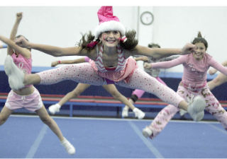 Madison Pearson does a toe touch jump at Action Athletics on Wednesday