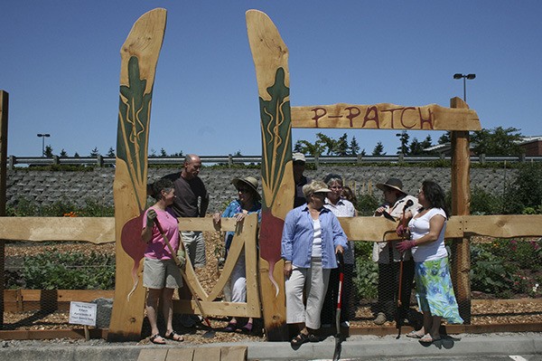 P-Patch owners in front of a plot constructed in Crossroads mall in 2009. The mall has been lauded as one example of successful “third places