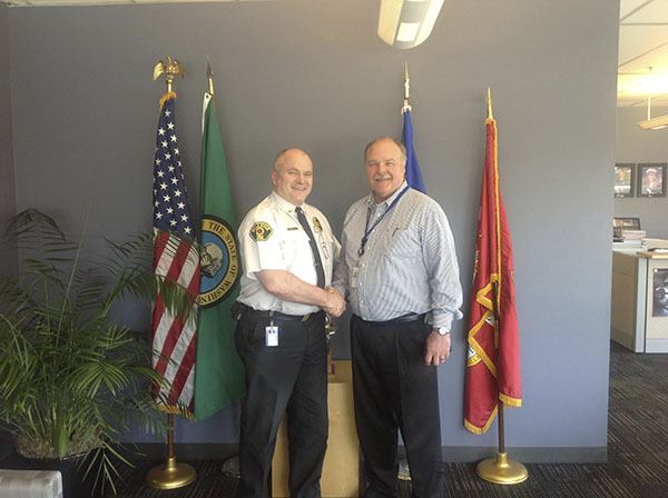 Battalion Chief Moulton (right) shakes hands with Chaplain Mike Ryan