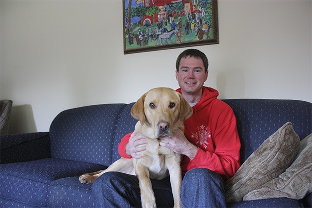 Andrew Brim with his dog Bob in their Bellevue home. Brim adopted Bob a little more than a year ago and the dog has helped him with some of the struggles the veteran has faced since he left the Marine Corps in 2004. Bob recently underwent kidney surgery for a giant kidney worm. He has since made a full recovery.