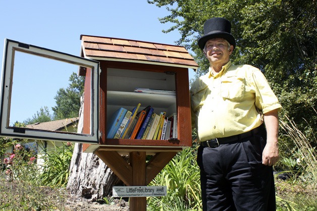 John Brangwin with his completed Little Free Library. He was the first to install one in Bellevue.