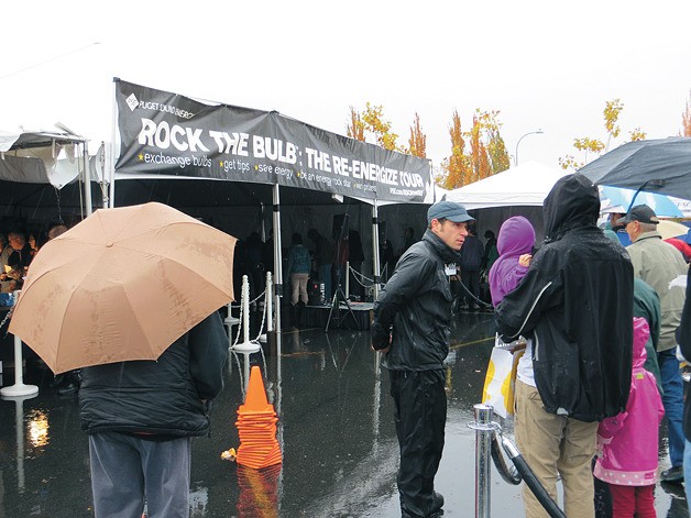 A PSE representative explains how the “Rock the Bulb” program works at Saturday’s Bellevue event.