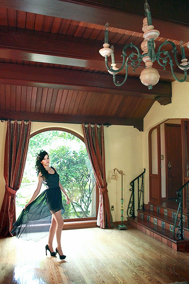 Claudia Burgos poses by the front window of the Winters House.
