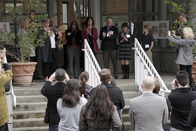 Community leaders and members joined KidsQuest officials Wednesday to celebrate the closing on the former Rosalie Whyel Museum of Doll Art building in downtown Bellevue