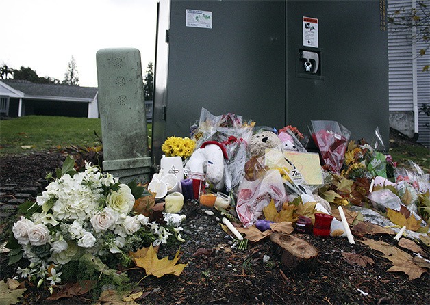 A memorial at the site of the Nov. 11 accident on Southeast 60th Street and 119th Avenue Southeast. It is alleged that the suspect