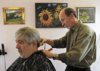 Hairacy Salon owner Red Rice works on his long-time customer Mark Berkowitz on Friday