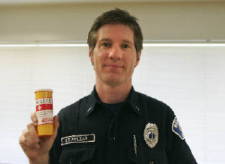 Bellevue Fire Department Lt. Todd McLean holds a Vial of LIFE kit in which a patient’s medical and contact information can be kept and put in the refrigerator.
