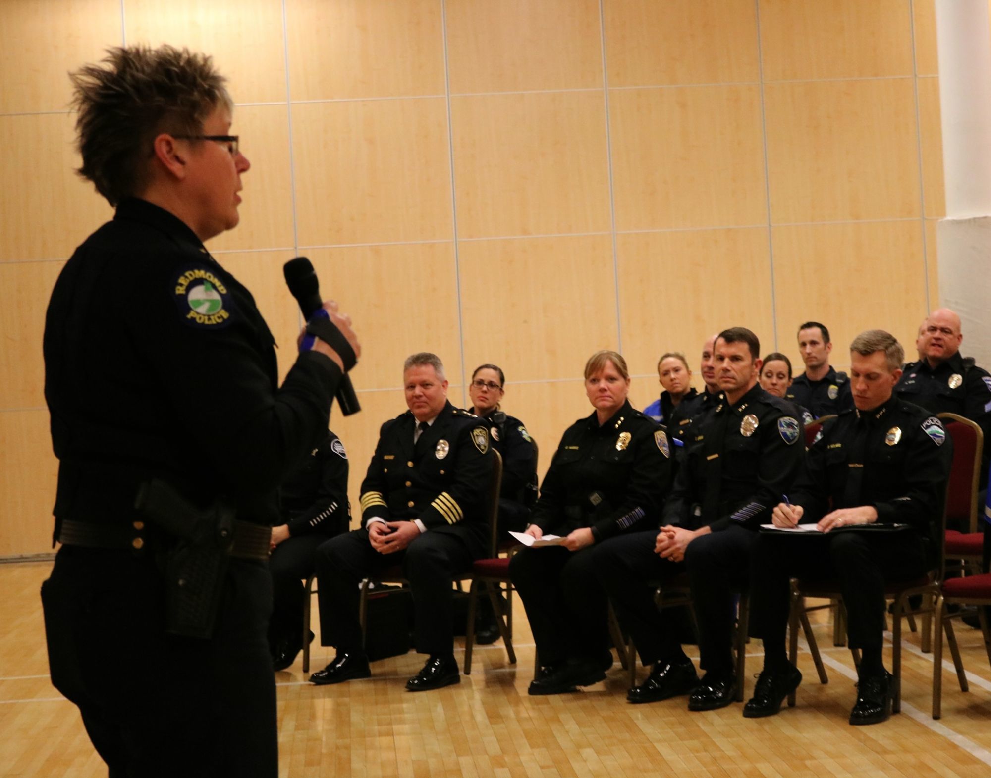 Redmond Police Department Chief Kristi Wilson, left, addresses the crowd — which featured five other Eastside police chiefs in the foreground — during Tuesday night’s Eastside Muslim Safety Forum at the Muslim Association of Puget Sound in Redmond. Andy Nystrom, Redmond Reporter