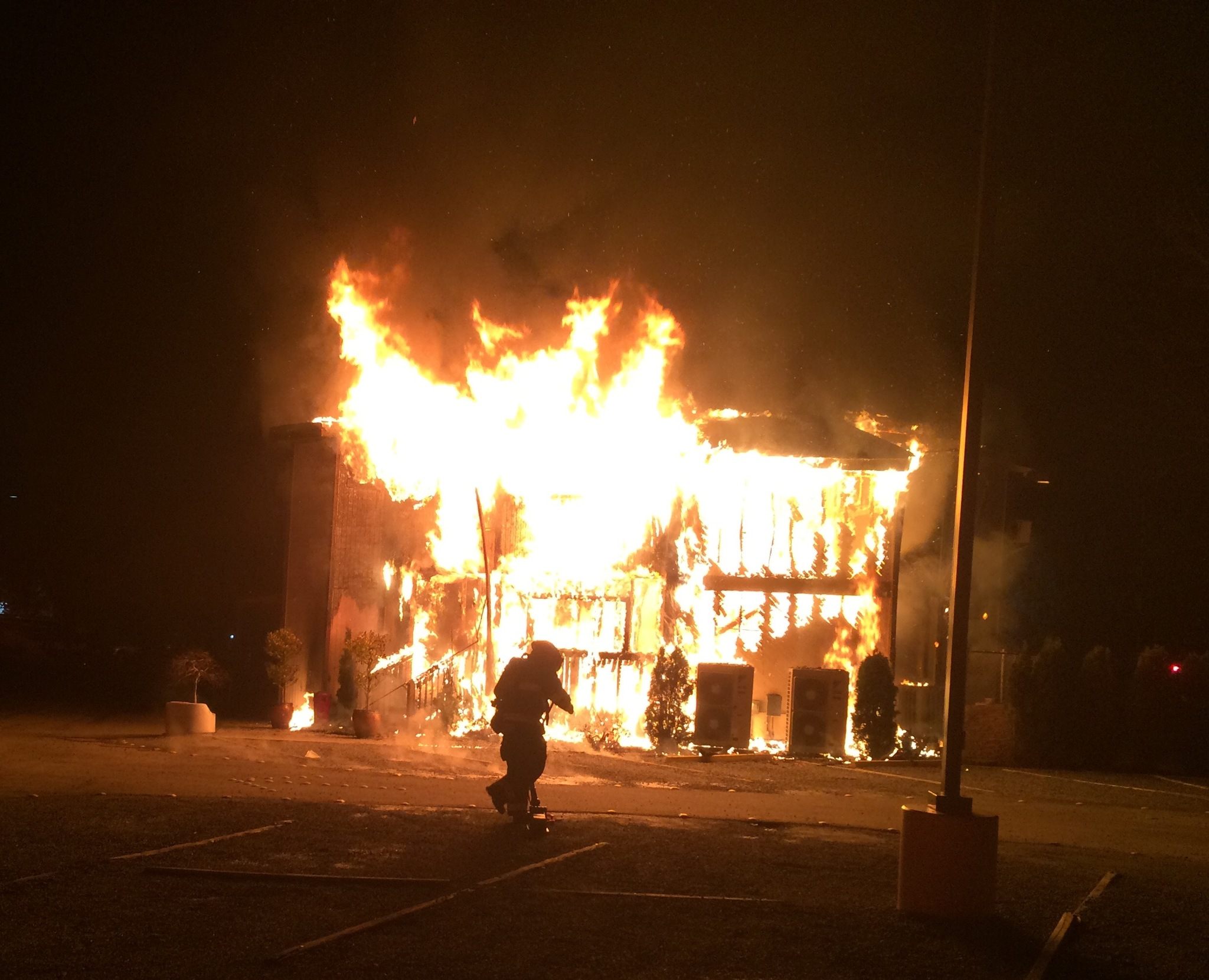 Photo courtesy of the Bellevue Fire Department                                A firefighter stands in front of the Jan. 14 blaze that has significantly damaged the Islamic Center of the Eastside.