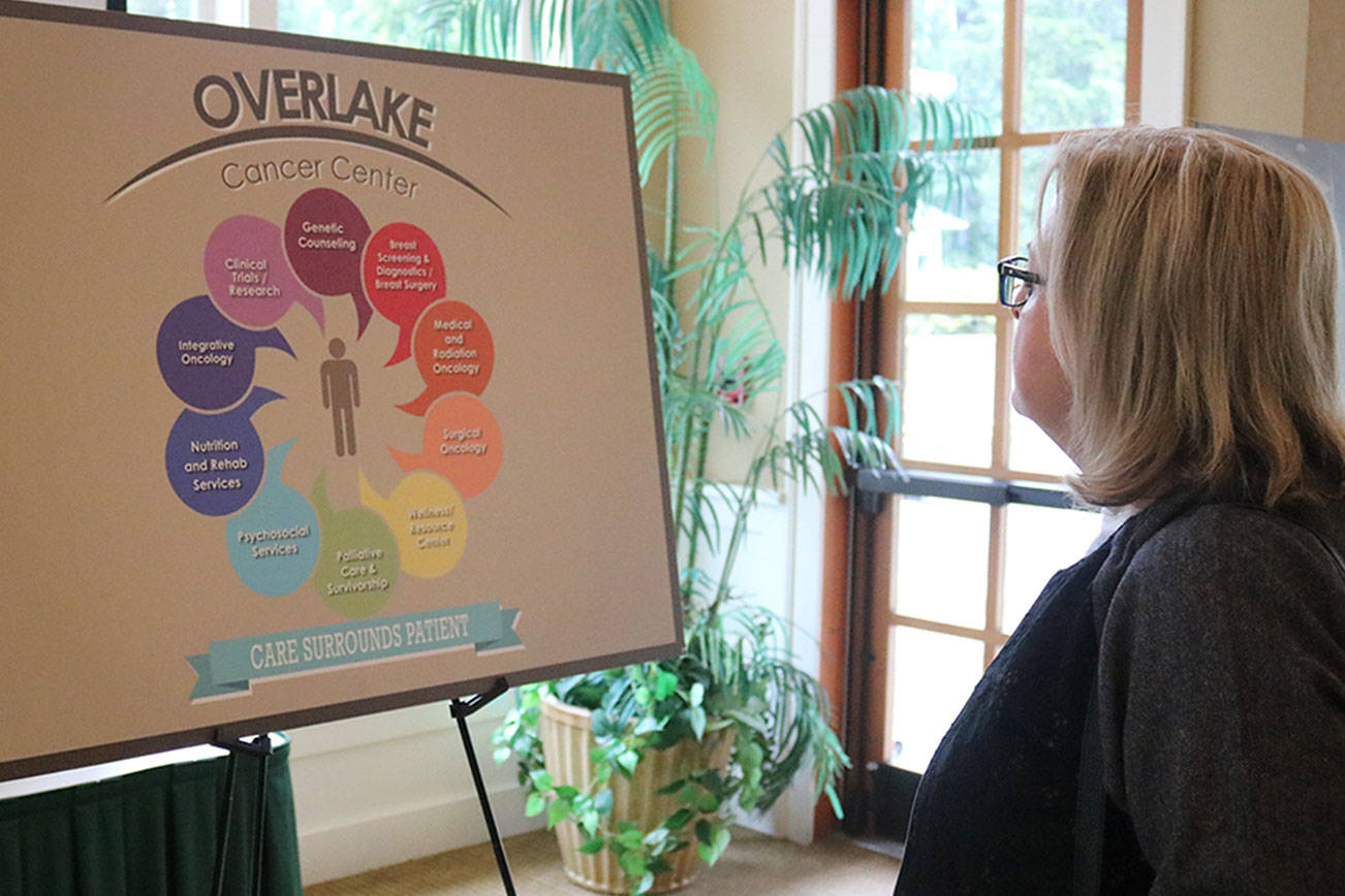 Beata Baker of Sammamish examines the Overlake Cancer Center model at a June Sammamish Chamber Luncheon at the Sahalee Way Country Club. Megan Campbell/staff photo