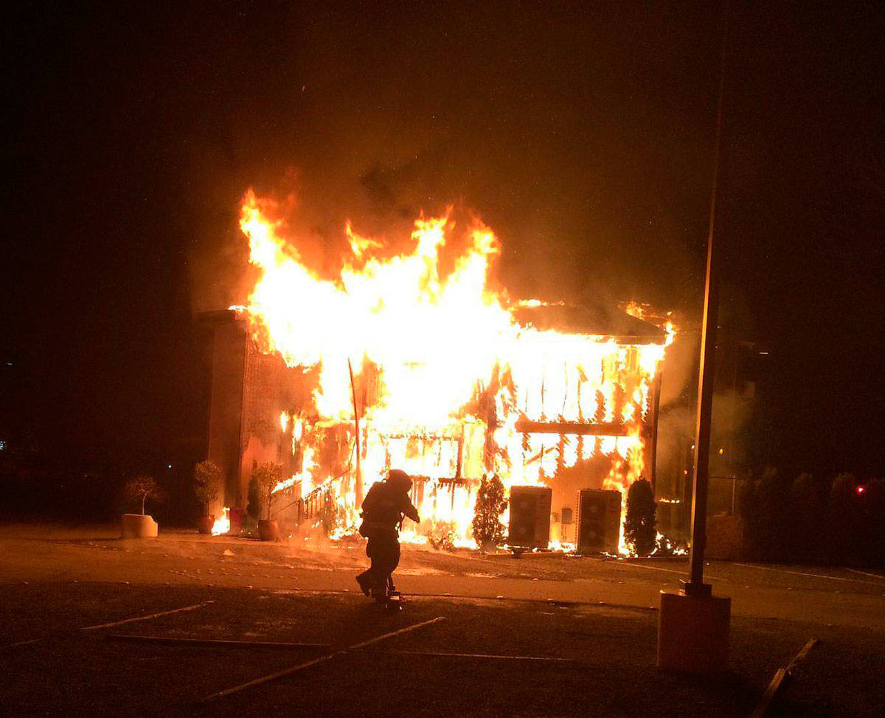 A firefighter stands in front of the Jan. 14 blaze that has significantly damaged the Islamic Center of the Eastside. Photo courtesy of the Bellevue Fire Department