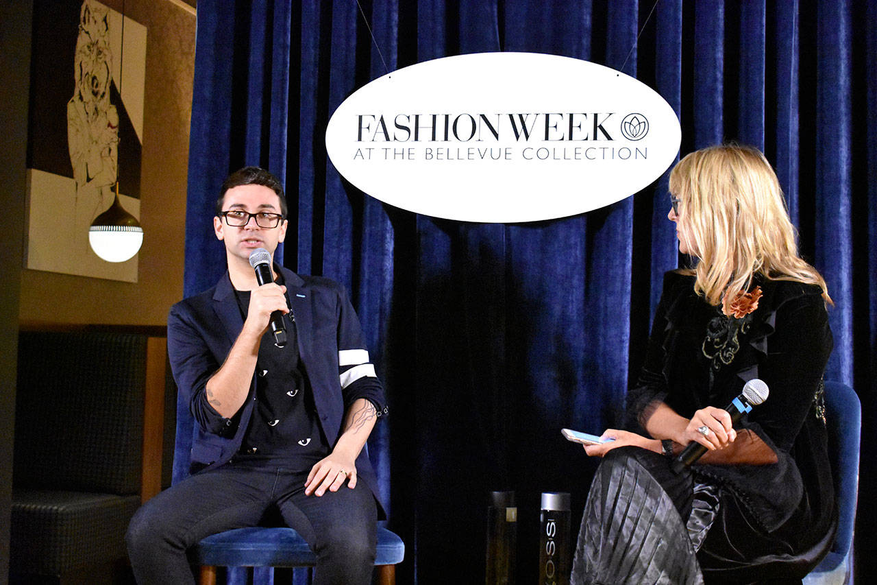 Designer Christian Siriano speaks with Terri Morgan of TCM Models during a press conference on Saturday. Raechel Dawson/staff photo