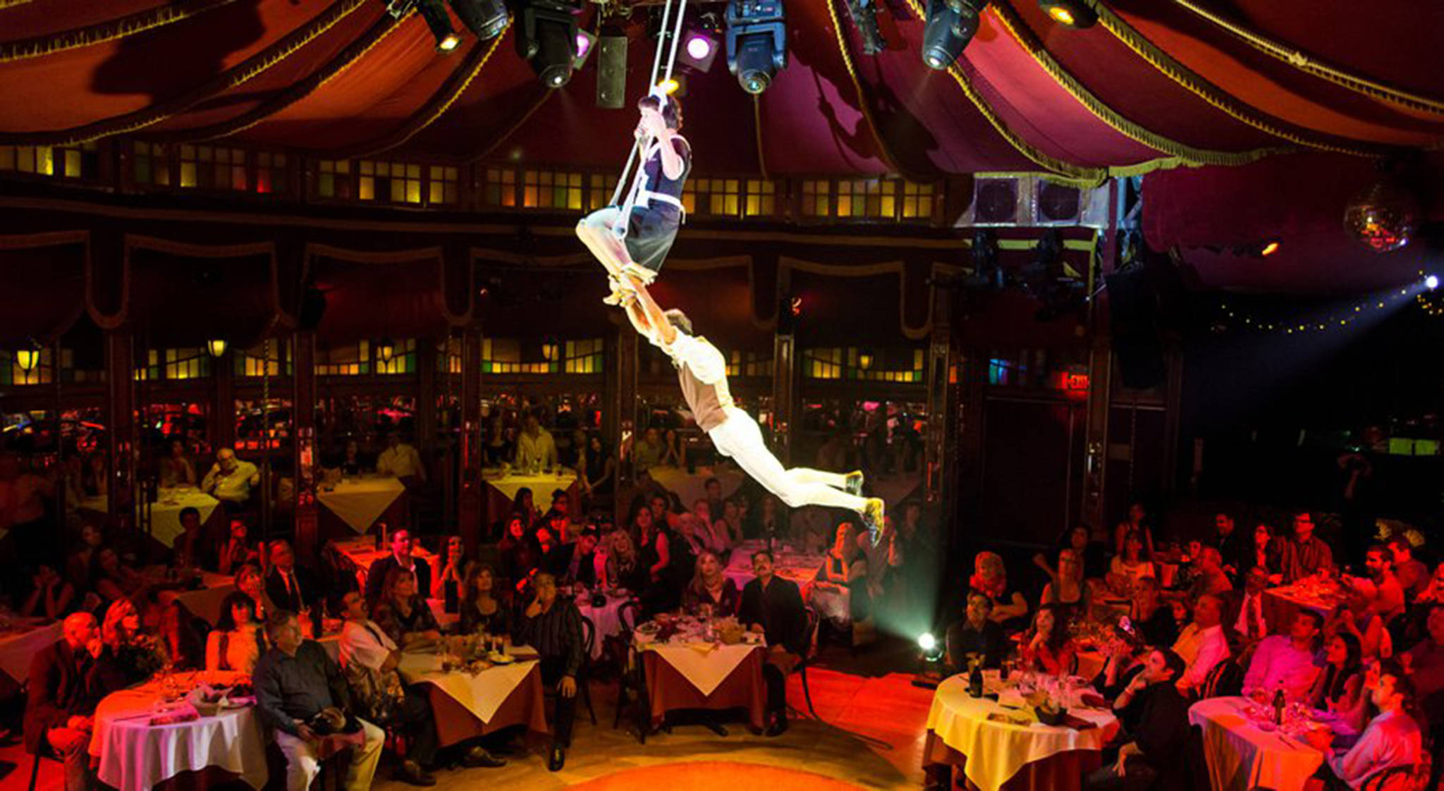 Performers fly through the Teatro ZinZanni spiegeltent. Courtesy of Mark Kitaoka