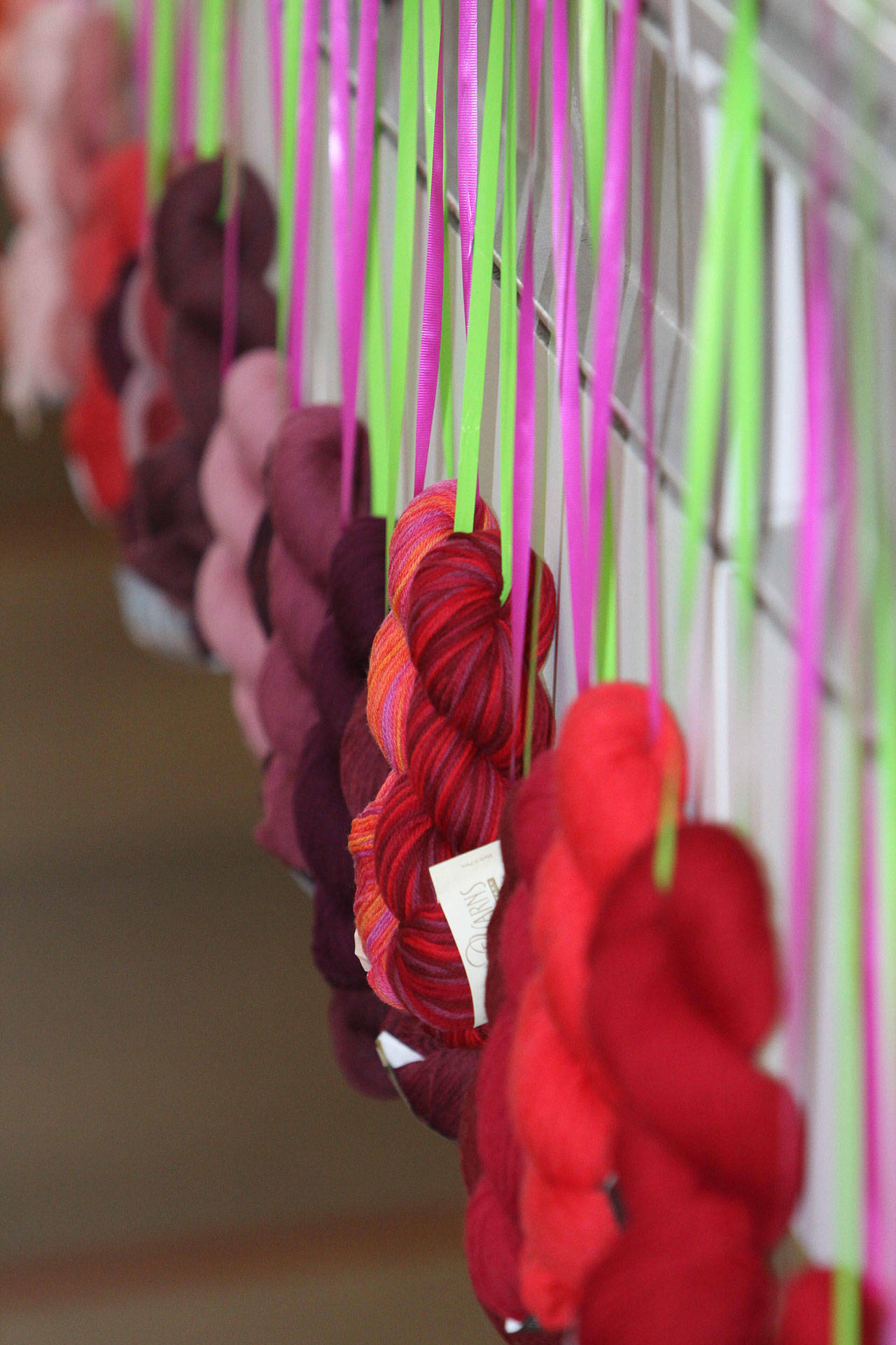 On Sunday, skeins of yarn are hung around the Marketplace and dropped in a “yarn drop.” Steve Schneider/Vogue Knitting LIVE