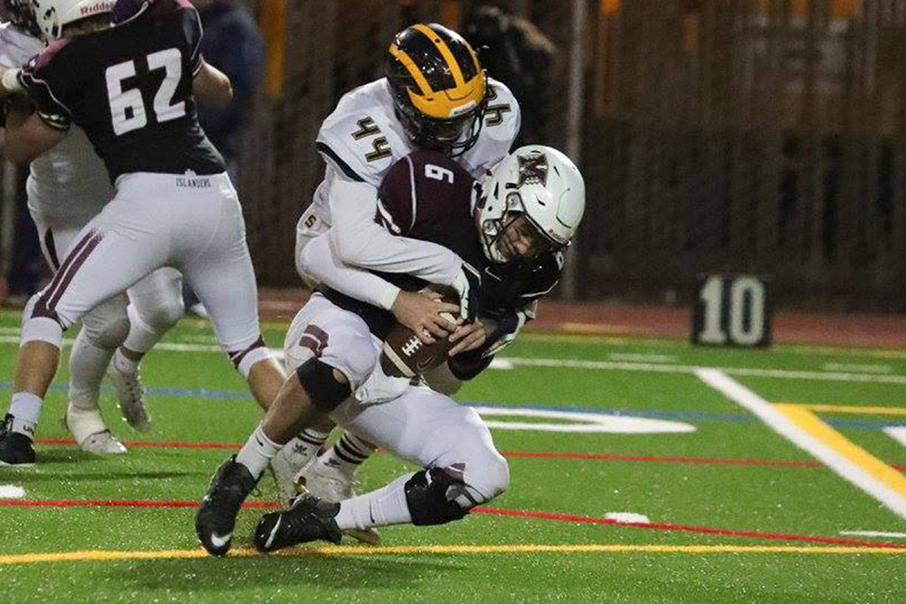 Photo courtesy of Don Borin/Stop Action Photography                                 Bellevue Wolverines linebacker Quinn Sullivan sacks Mercer Island quarterback Nikhil Nayar in a matchup between rival teams in a contest earlier this season. Bellevue, which has surrendered a total of 47 points in the past four games, will face Oak Harbor in the first round of the Class 3A state playoffs at 1 p.m. on Nov. 11 at Bellevue Memorial Stadium.