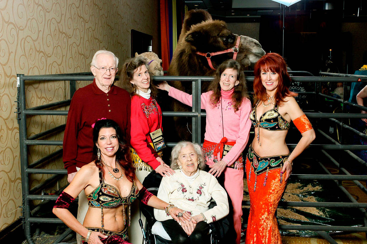 Áegis Living seniors get their photo taken with a belly dancer and a camel on Nov. 1 at the Bellevue Hilton. Photo courtesy of Meeghan Black/Áegis Living