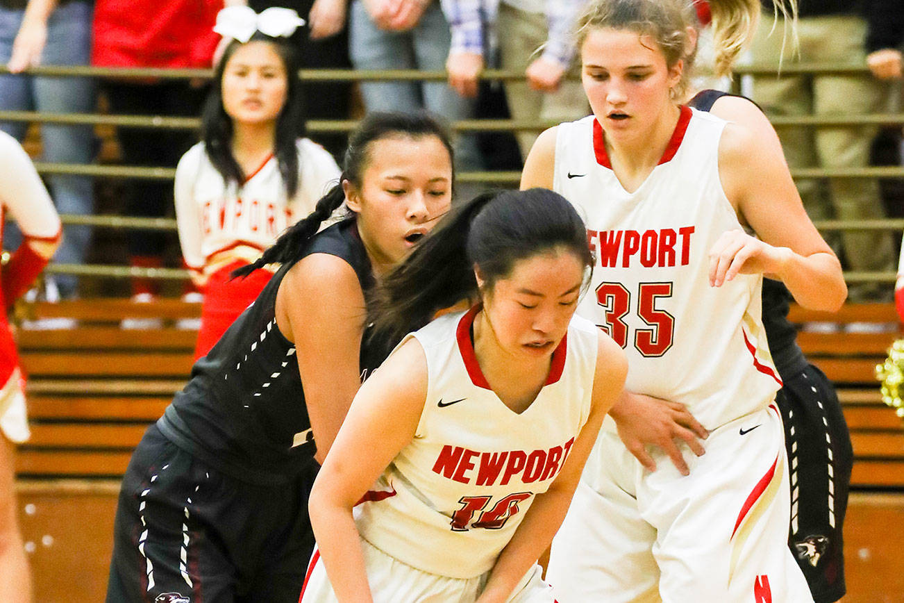 Photo courtesy of Rick Edelman/Rick Edelman Photography                                Newport Knights junior guard Nicole Chan, center, scored a game-high 21 points against the Eastlake Wolves on Dec. 8 at Newport High School in Factoria. Eastlake defeated Newport 70-52.