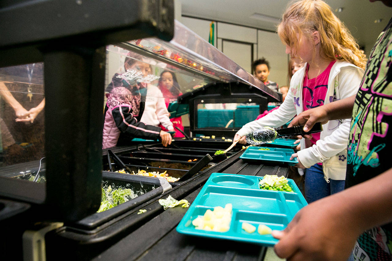Students at Stevens Elementary in Spokane put food on their trays. Photo courtesy of the state Legislature