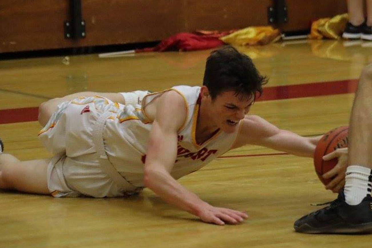 Photo courtesy of Don Borin/Stop Action Photography                                Newport senior guard Elliot Thompson (left) dove for a loose ball against the Issaquah Eagles on Jan. 26 at Newport High School in Factoria. Thompson scored 22 points against Issaquah.