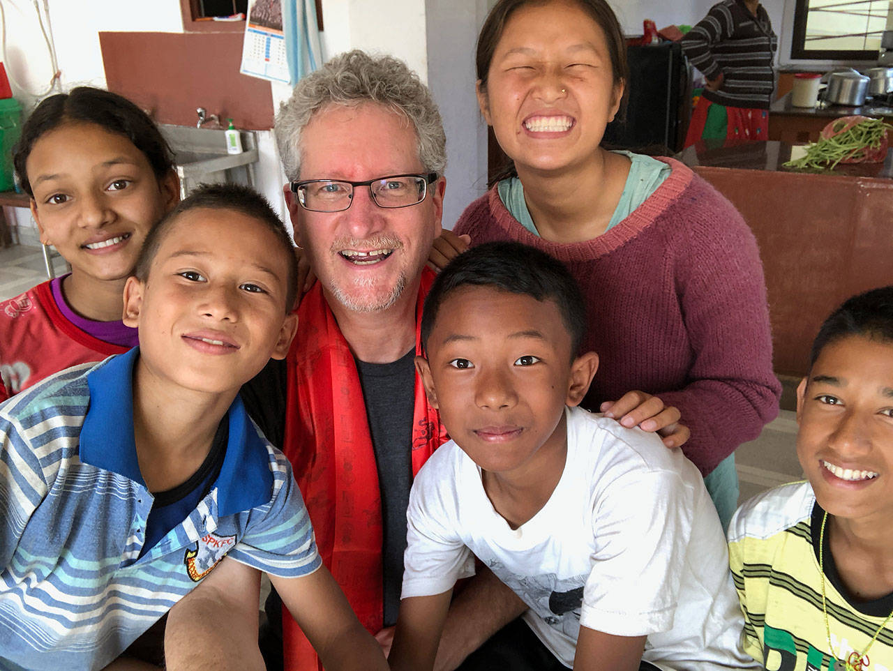 Rob Rose, center, with children in Nepal. Photo courtesy of Rob Rose