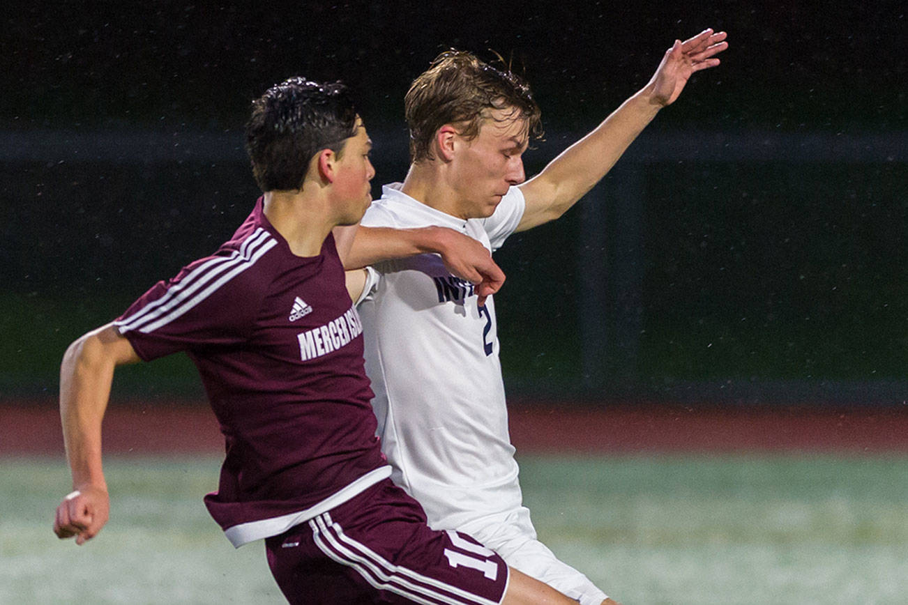 Photo courtesy of Patrick Krohn/Patrick Krohn Photography                                Mercer Island player Alex Platou, left, and Interlake defender Charlie Myhran, right, battle for possession of the ball in the first half of play on April 11 at Interlake High School in Bellevue. Mercer Island defeated Interlake 2-1 in the contest.