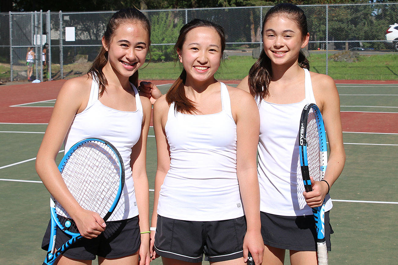 Photo courtesy of Matthew Perlman                                Interlake Saints singles player Addie Eklund, left, won the KingCo 3A singles tournament at Mercer Island High School on May 4. The doubles duo of Olivia Sun (center) and Sylvia Eklund (right) captured the KingCo 3A doubles tournament championship.